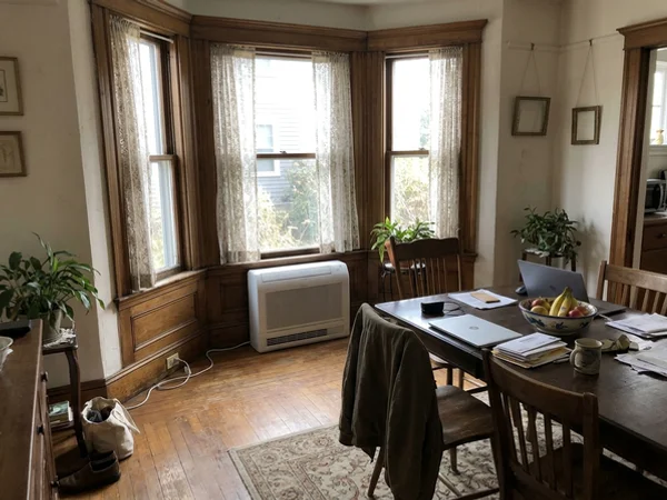 Ductless floor console unit under a bay window in a Riverdale home
