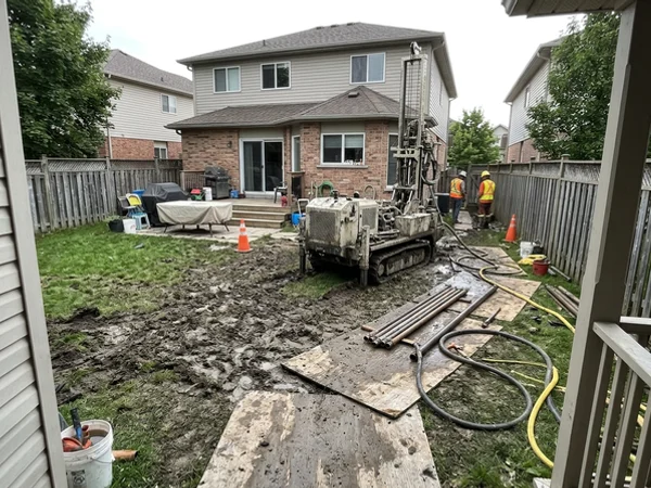 Geothermal drilling rig in a suburban backyard