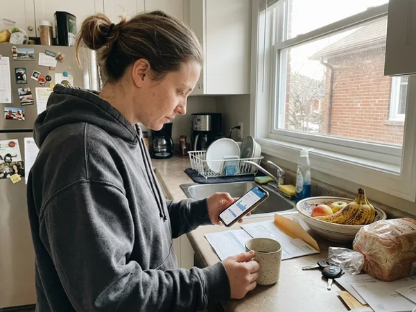 Homeowner checking a lower gas bill on a phone
