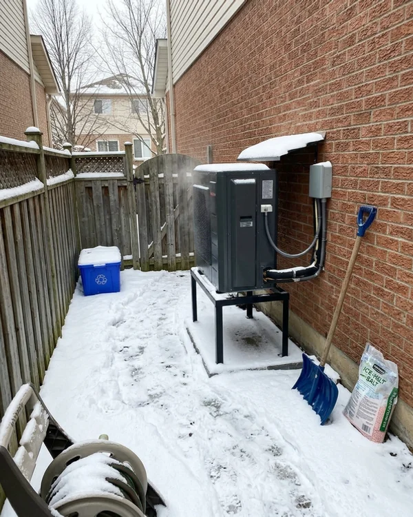 New cold-climate heat pump running in the same side yard after replacement