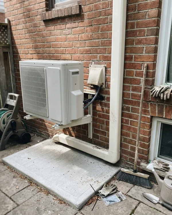 New Daikin Fit heat pump next to the same furnace vent after the hybrid install