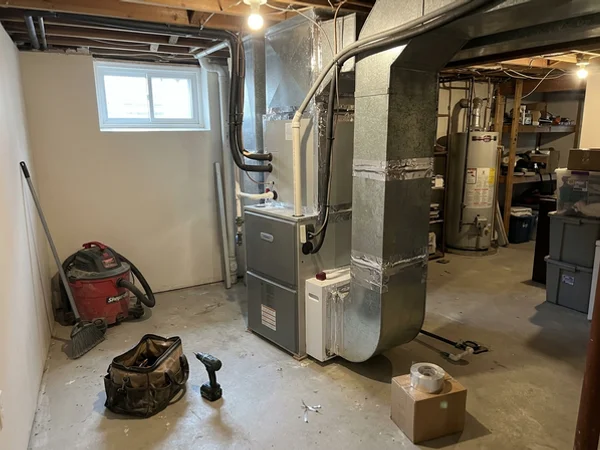 New air handler connected to existing ductwork in a Toronto basement