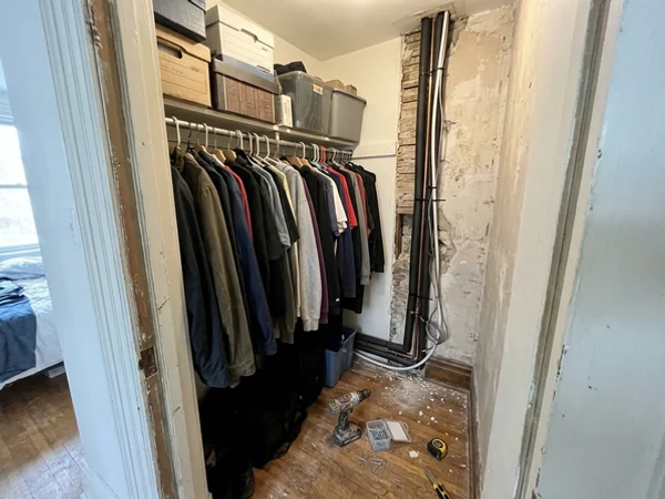 Refrigerant line set routed through a closet corner before boxing in