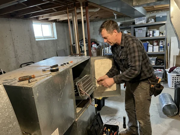 Strip heat kit being installed in a Gree air handler