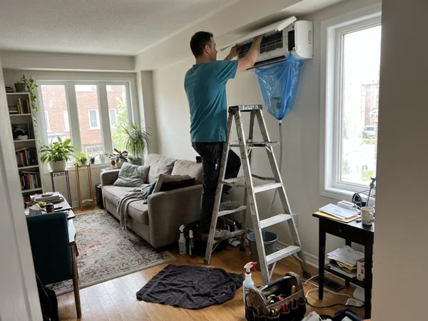 Technician servicing an existing Gree ductless head